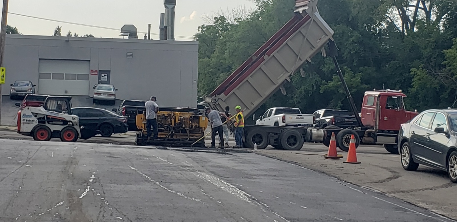 Alpha Paving Solutions dump truck hauling aggregate on Hamilton job site